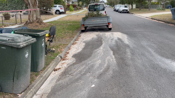 Asbestos debris flowing down the street and entering the stormwater system